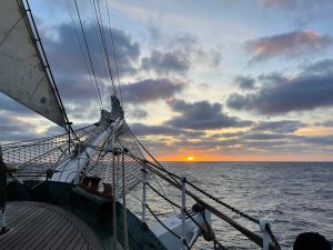 sailing towards a sunset